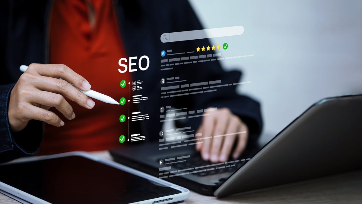 SEO specialist reviewing ranking analytics and an optimization checklist